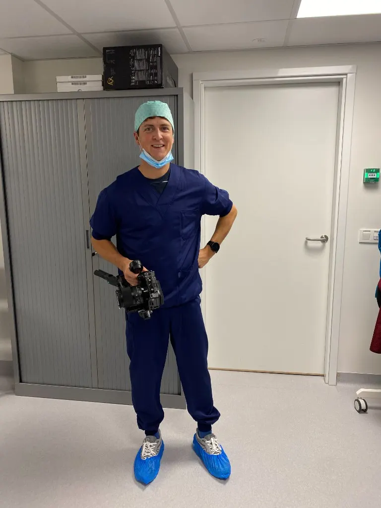 Antoine Similon in medical scrubs, holding a camera gimbal on a hospital shoot
