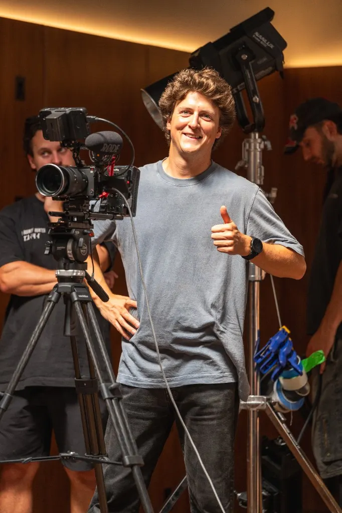 Antoine Similon on set with a cinema camera and lighting, giving a thumbs-up