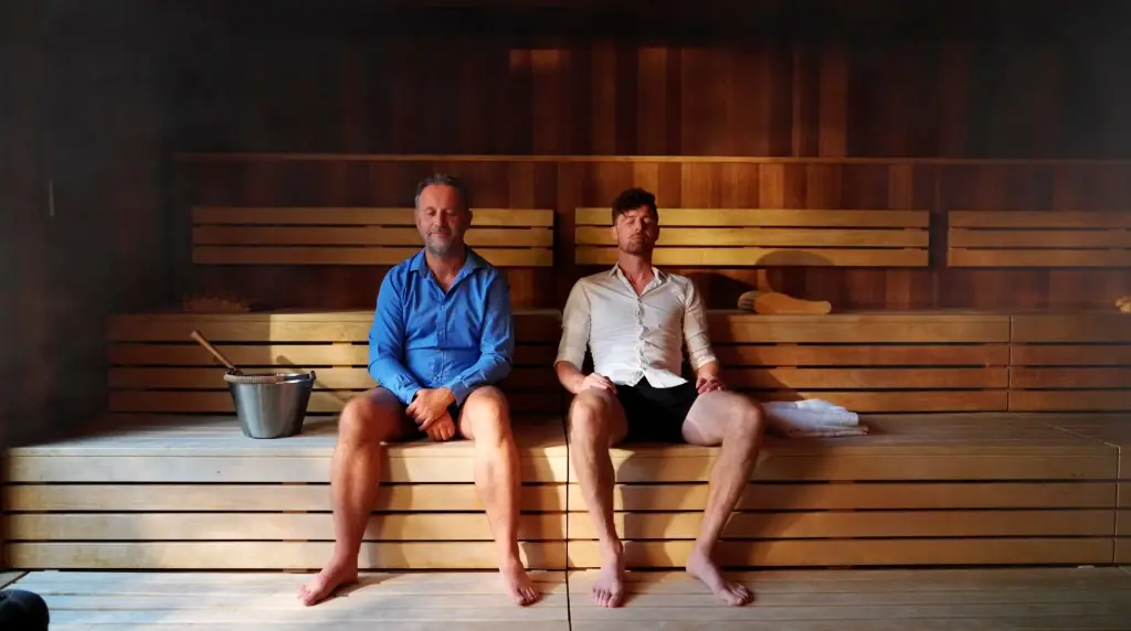 Two people in a sauna, still from a branded commercial